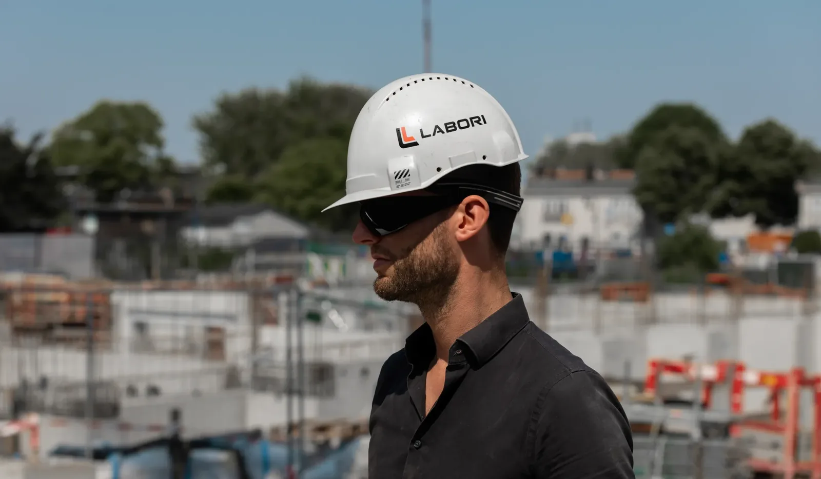 LABORI team member in a hard hat on a commercial construction site