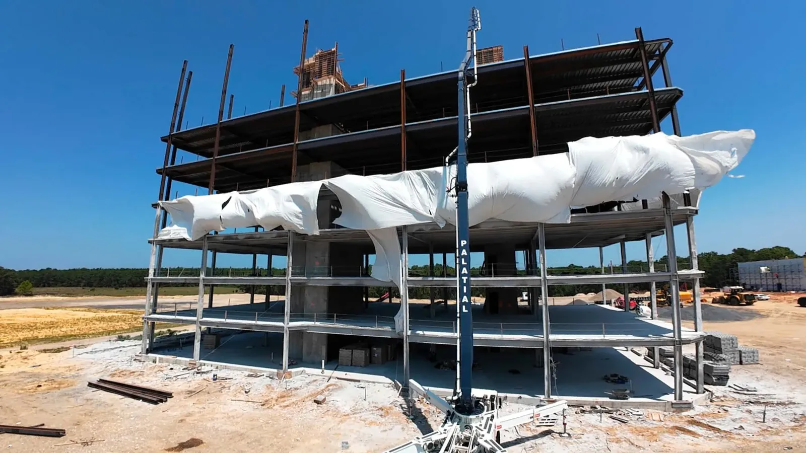 Multi-story concrete and steel structure with a concrete pump